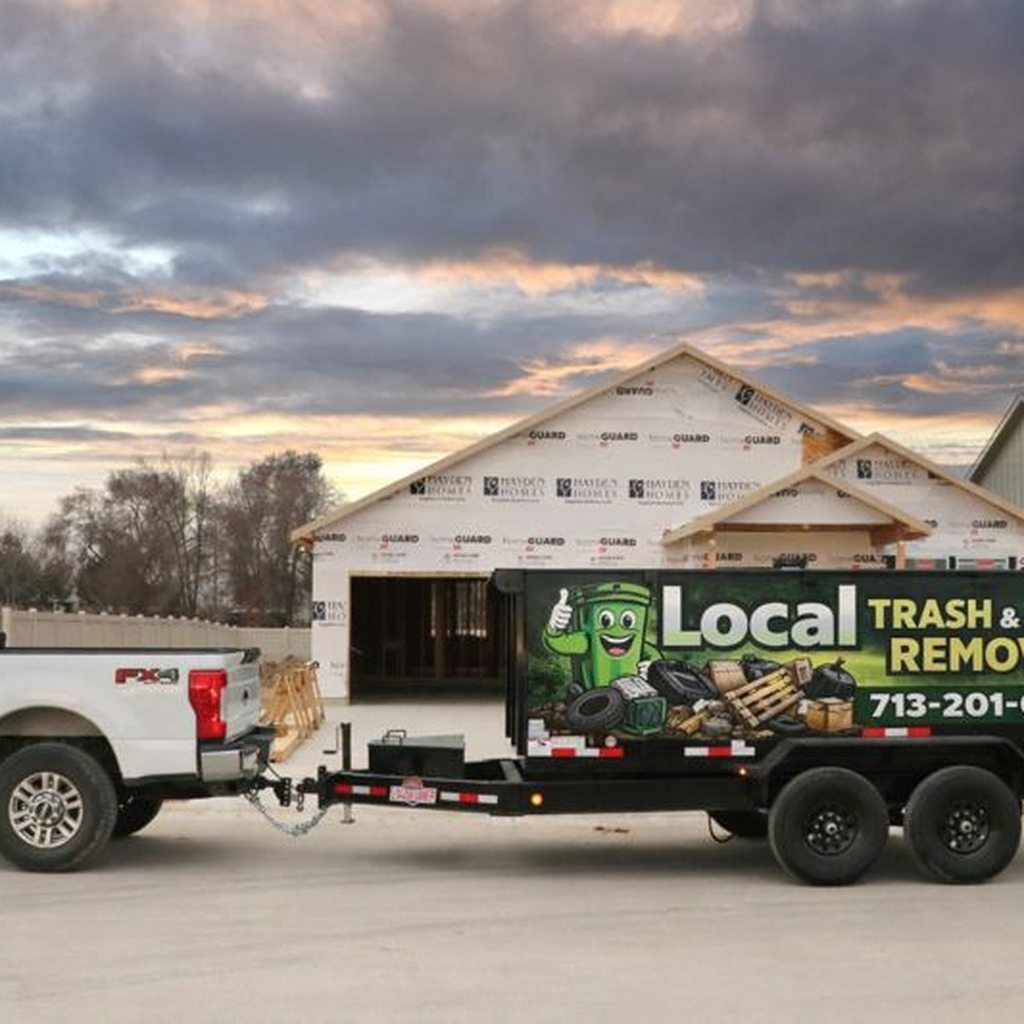 Construction debris removal truck and trailer at jobsite